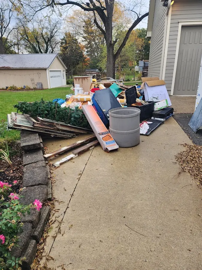 Dumpster being loaded with debris for Estate Cleanout Dumpster Rental in Glastonbury